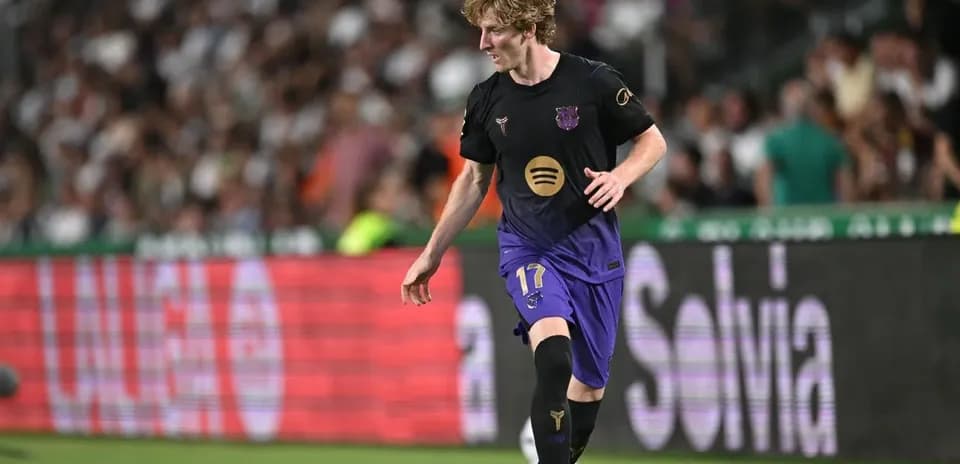 Player in Barcelona kit dribbling the ball on field