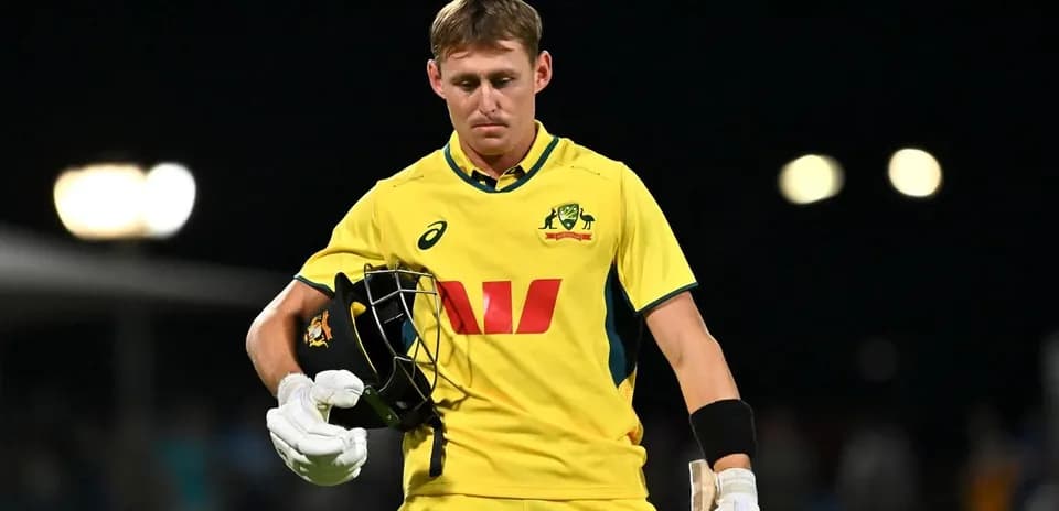 Australian cricketer walking off field after dismissal