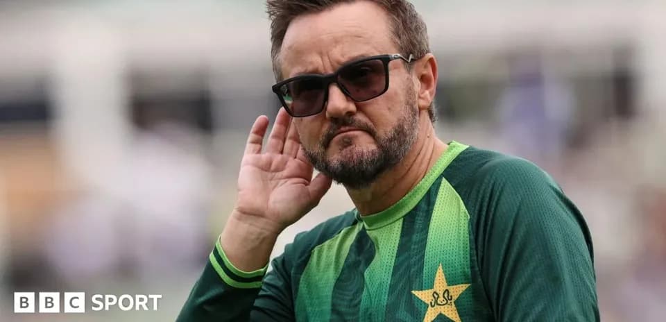 Cricket coach listening intently during practice session