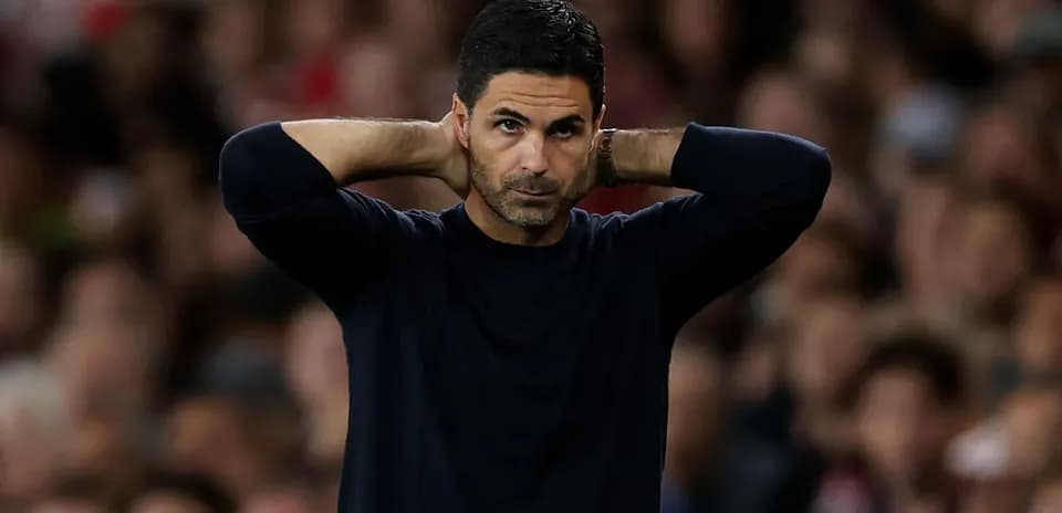 Coach with hands on head during match