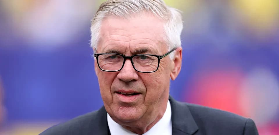Man in glasses wearing a suit, speaking