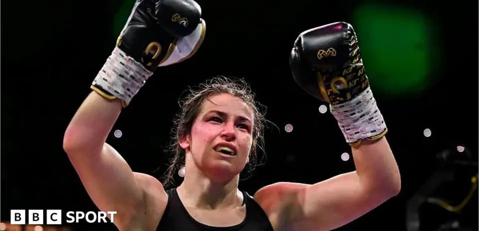 Boxer celebrating victory with raised fists in gloves