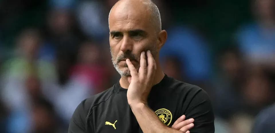 Coach observing match with thoughtful expression