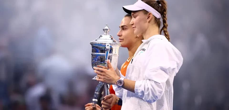 Two tennis players holding trophies after final match