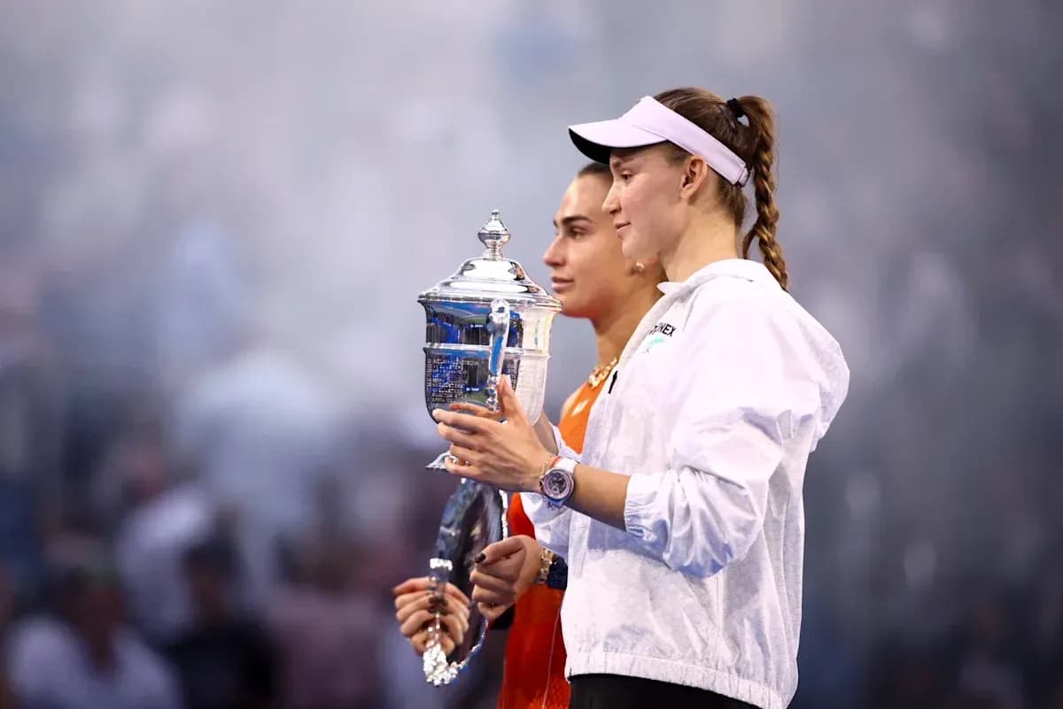 Two tennis players holding trophies after final match