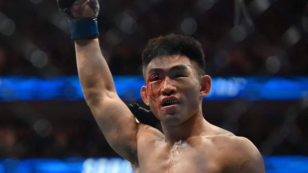 Fighter celebrating victory with blood on face
