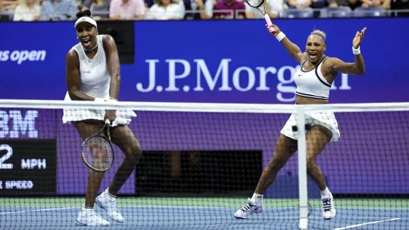 Venus and Serena Williams celebrating during match