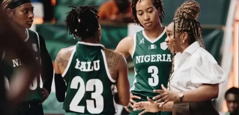 Coach discussing strategy with Nigeria women's basketball team