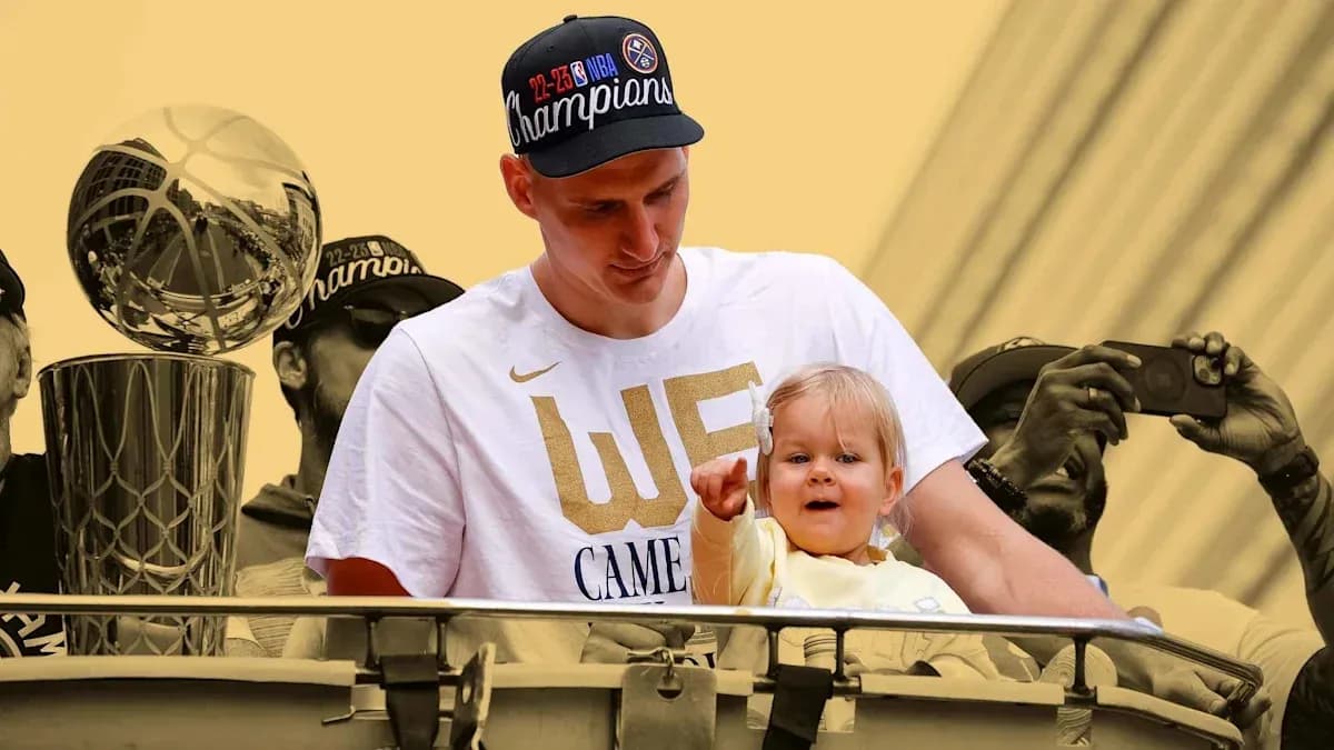 Player holding child during championship celebration parade