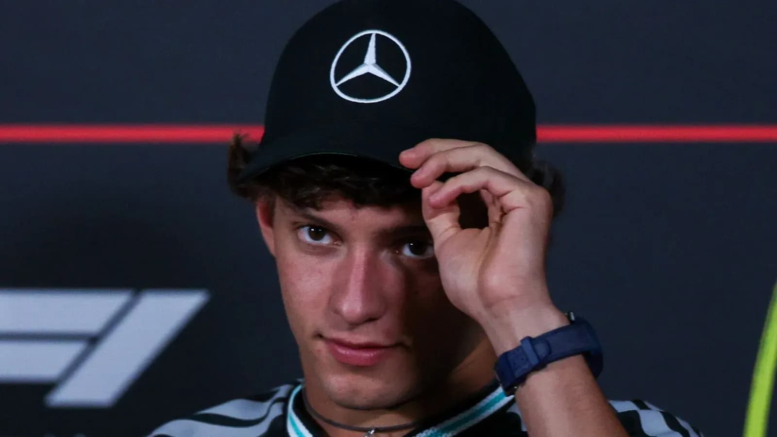 Young man wearing a Mercedes cap at event