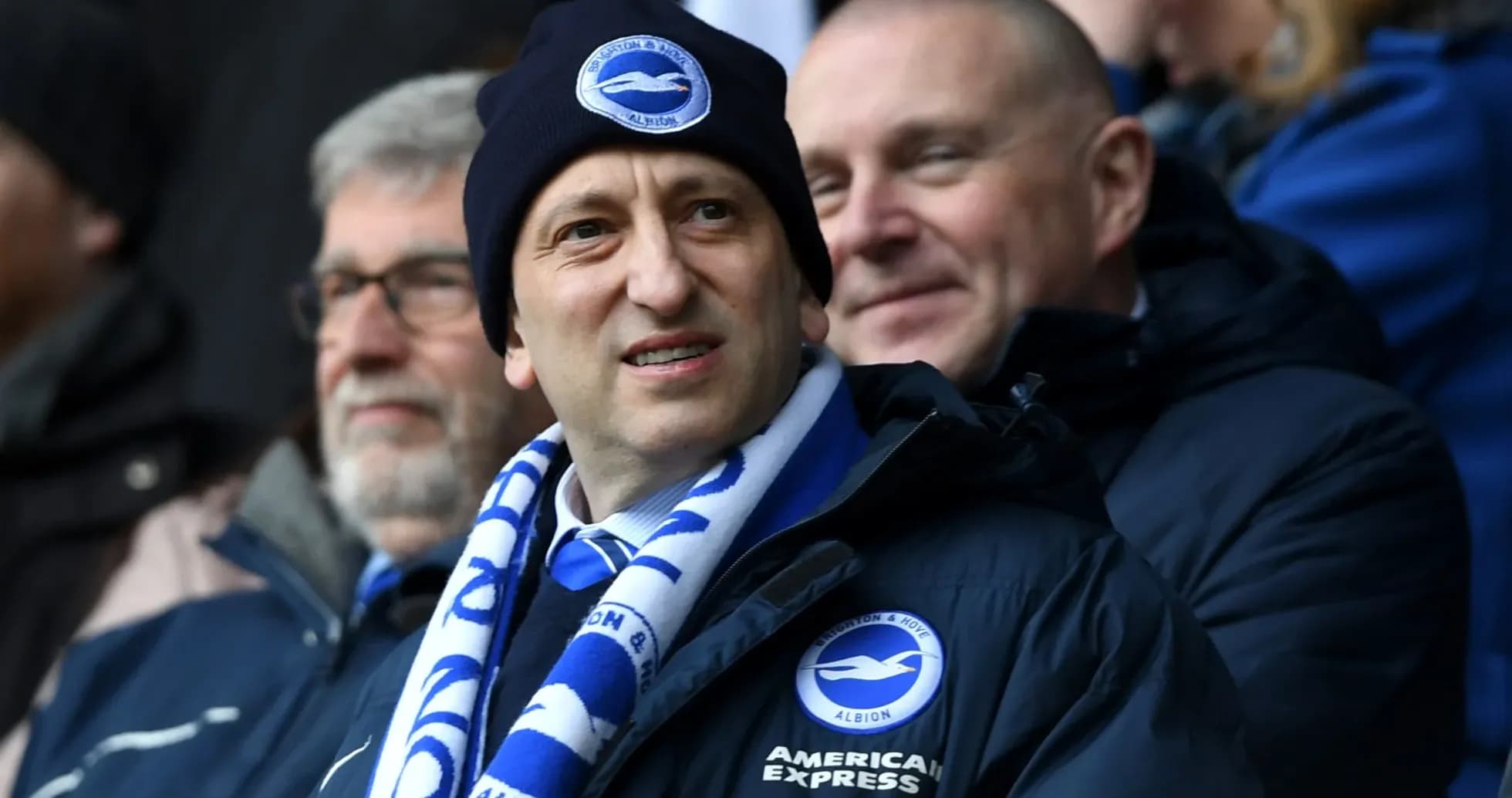 Man in beanie and scarf at football match