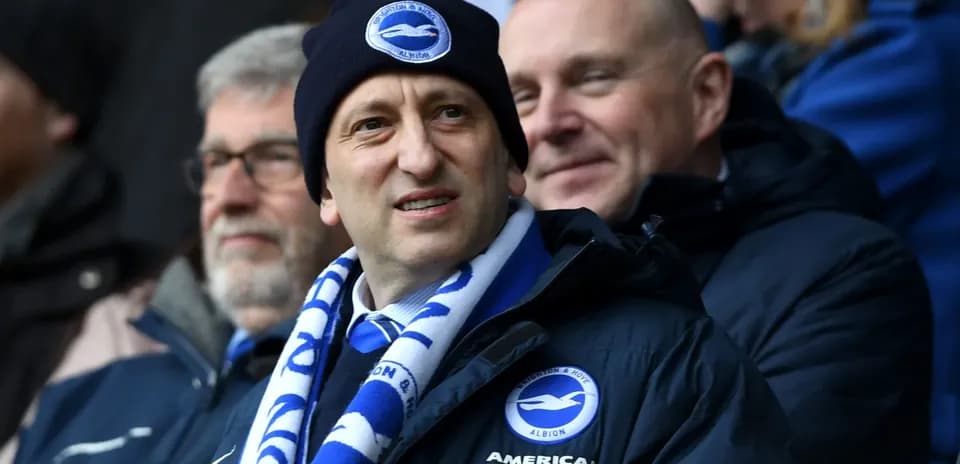 Man in beanie and scarf at football match