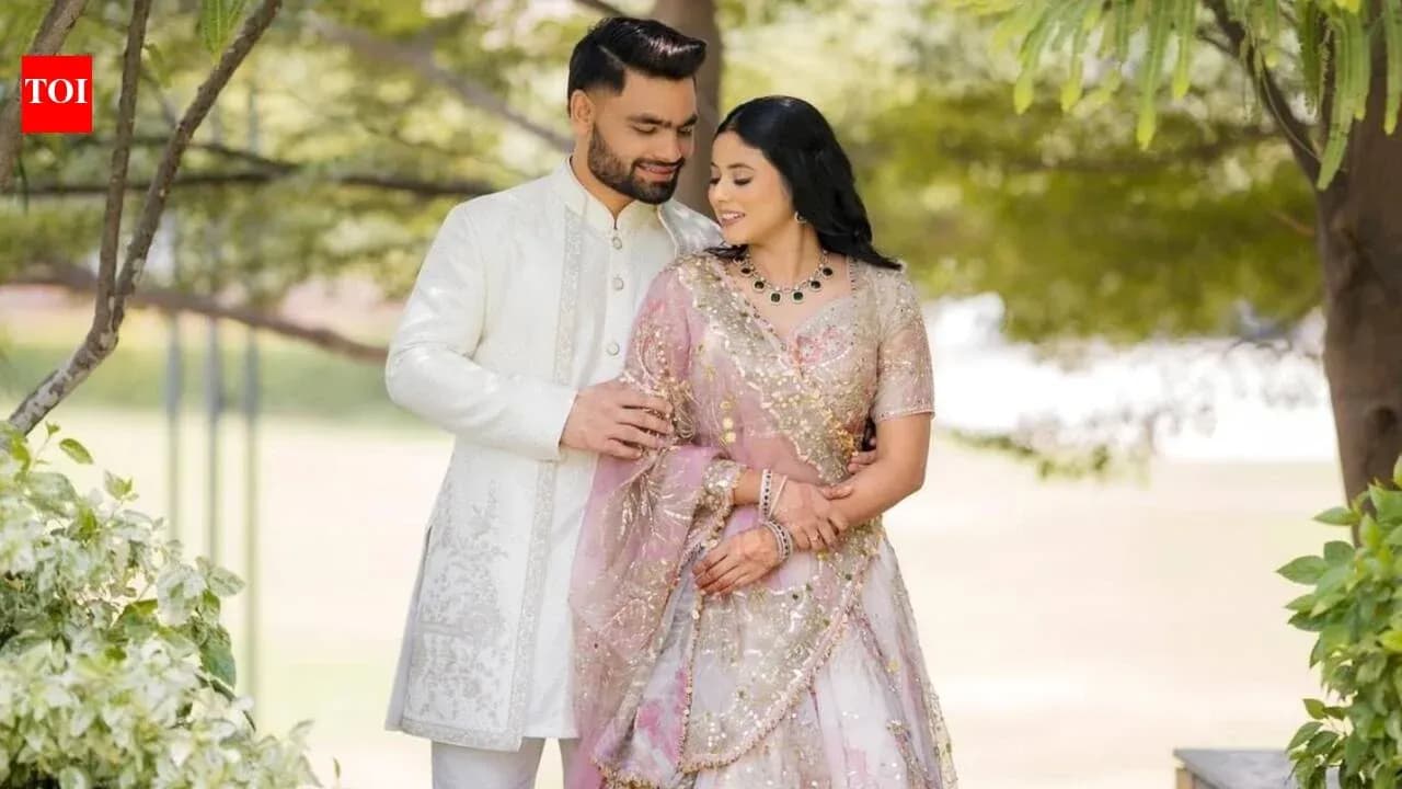 Couple in traditional attire posing outdoors