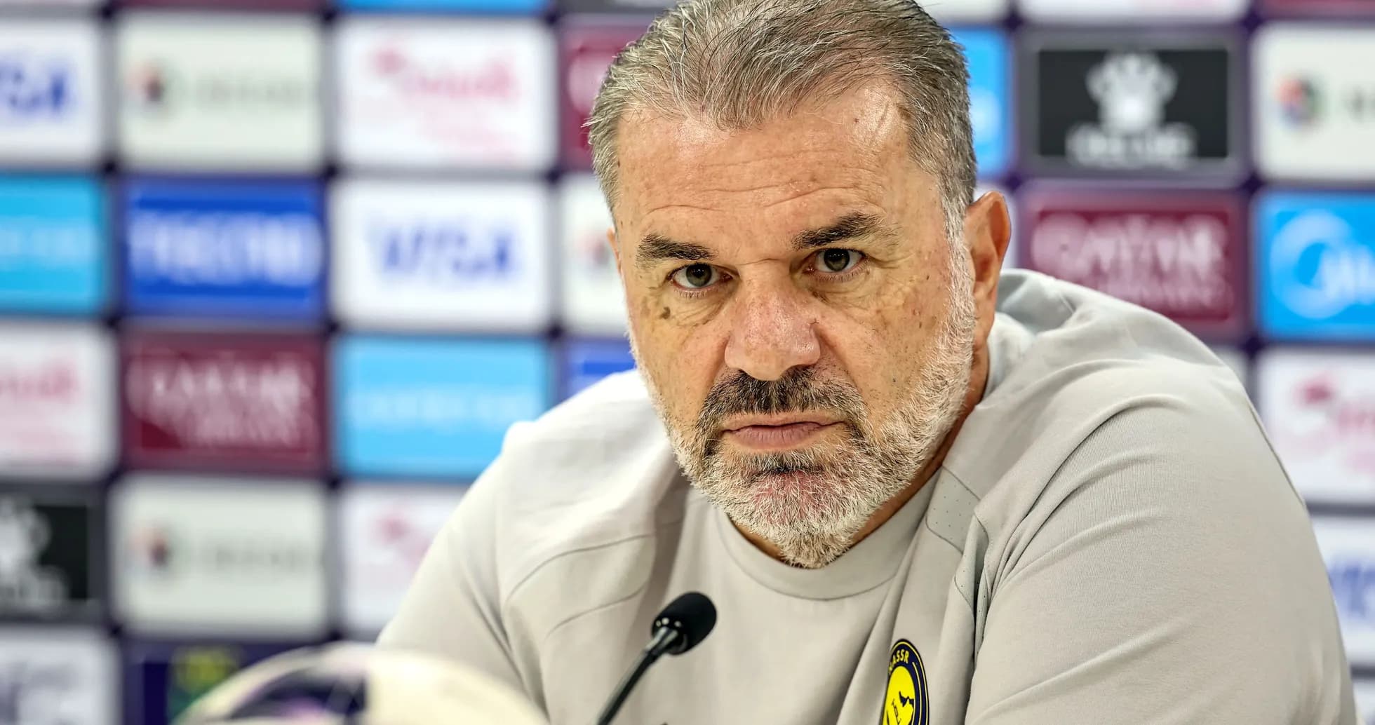 Manager speaking at press conference with microphone