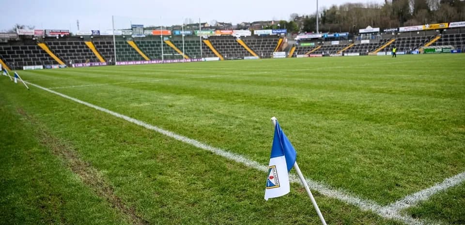 Corner flag on a rugby field with empty stands