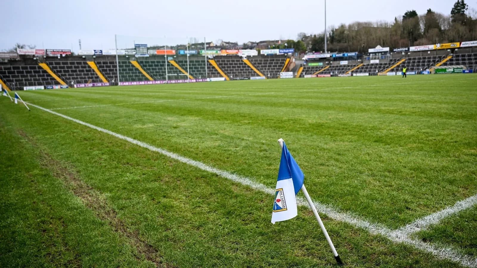 Corner flag on a rugby field with empty stands