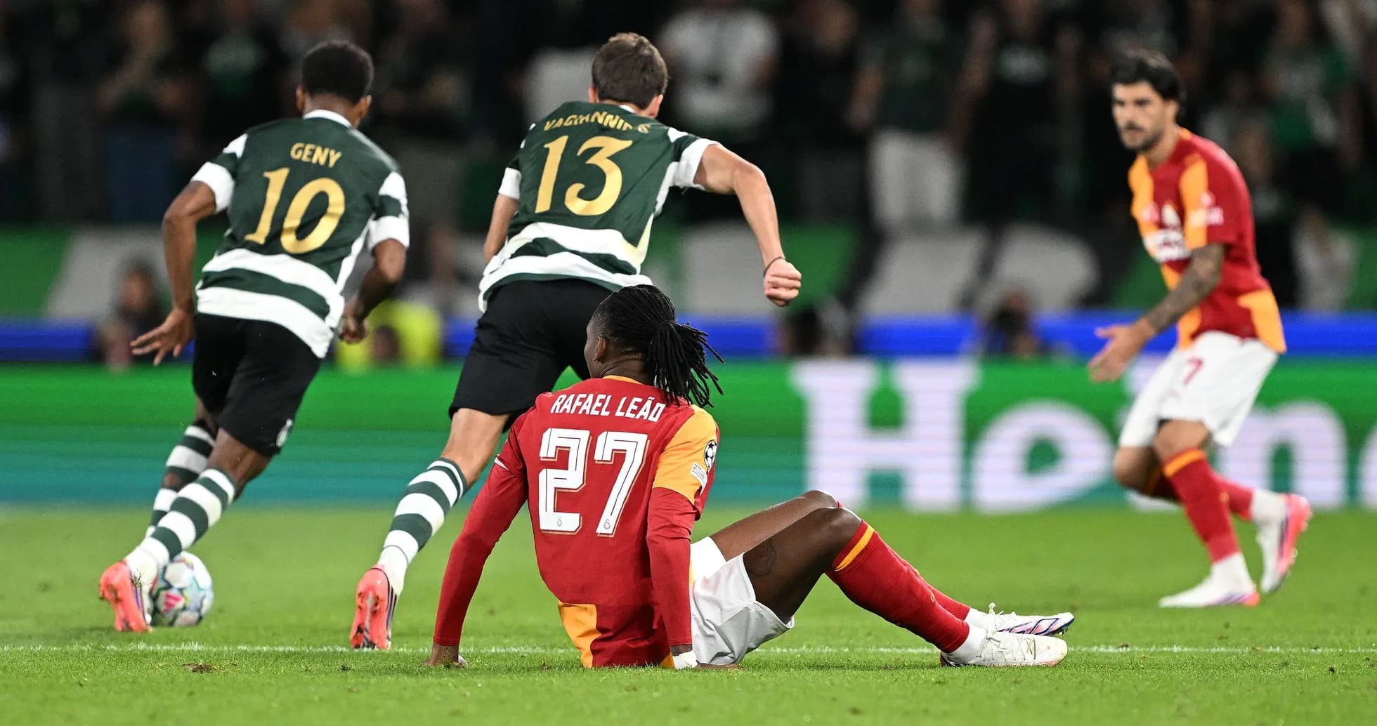 Rafael Leão sitting on pitch during match action