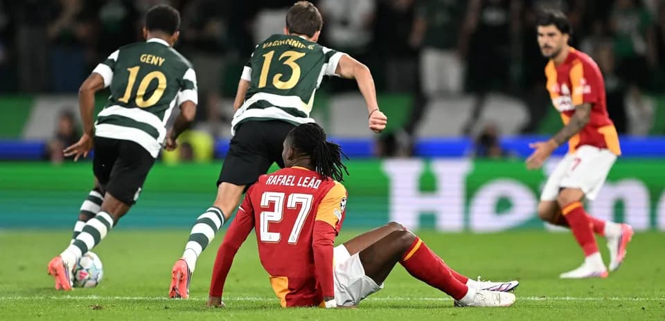 Rafael Leão sitting on pitch during match action