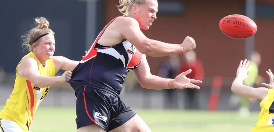 Player passing the ball while being tackled