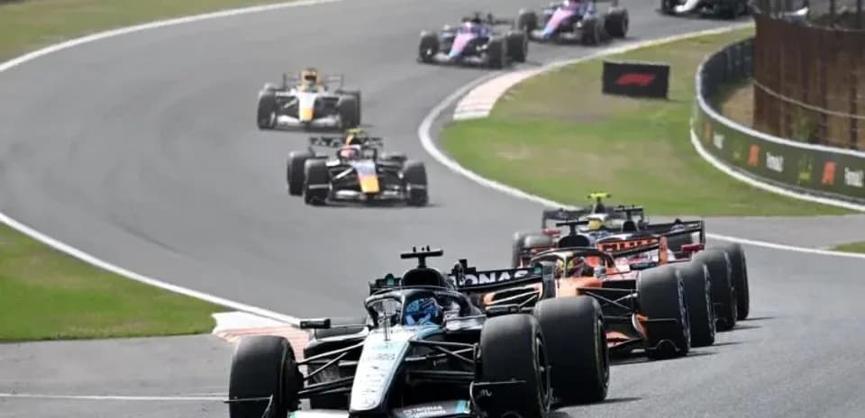 Multiple Formula 1 cars racing on a track