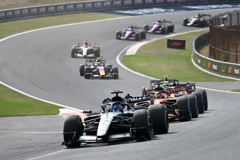 Multiple Formula 1 cars racing on a track
