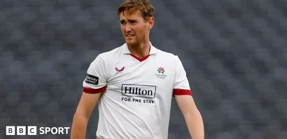 Cricketer wearing Lancashire shirt on the field