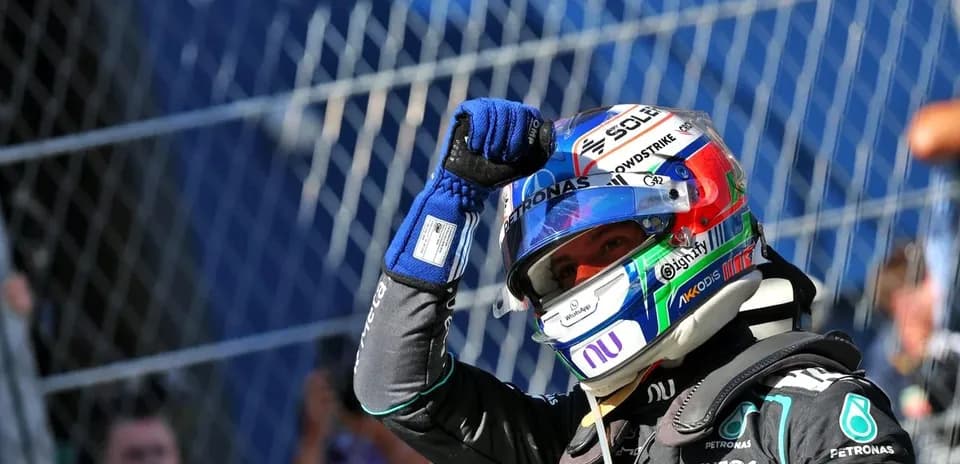 Driver celebrating after race victory in pit area