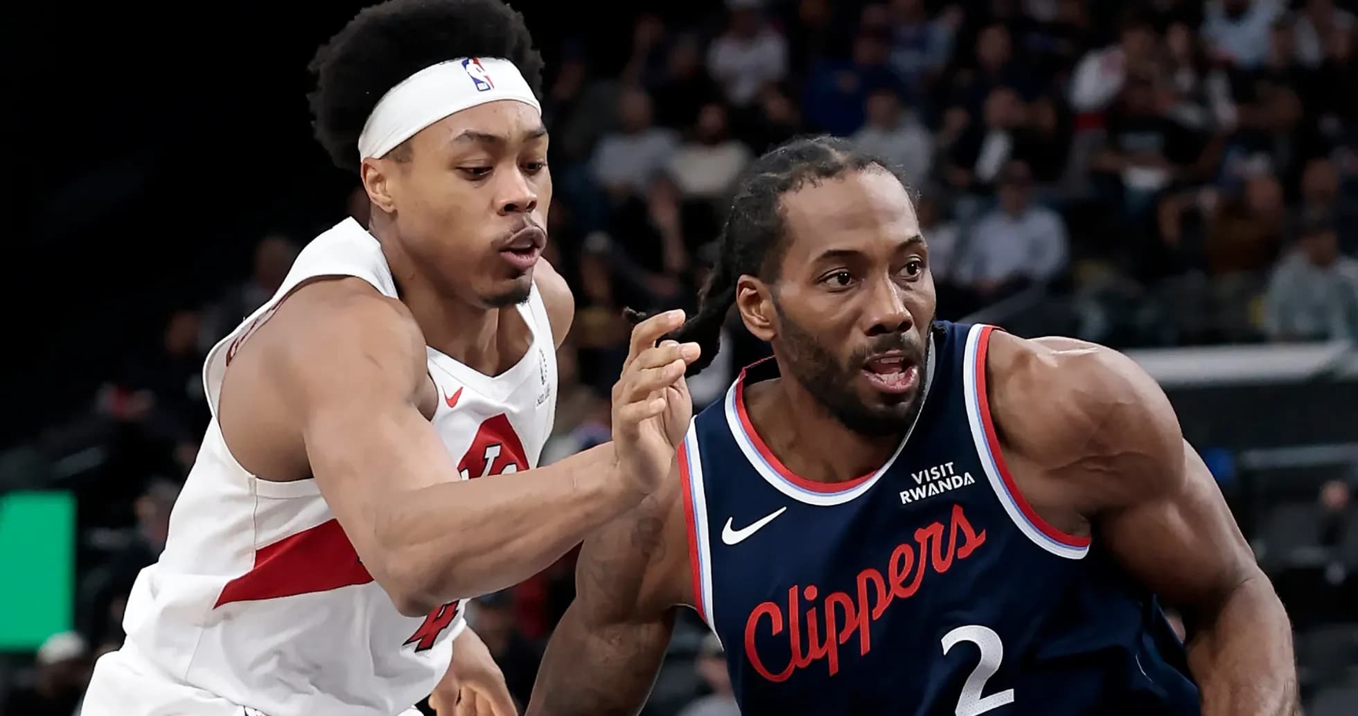 Two players competing for the ball during NBA game