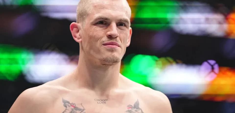 Fighter with tattoos posing in the ring