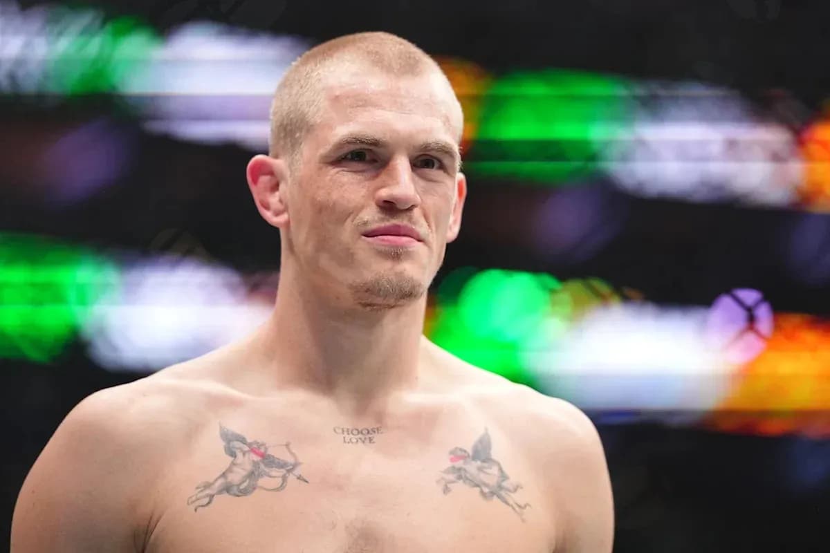 Fighter with tattoos posing in the ring