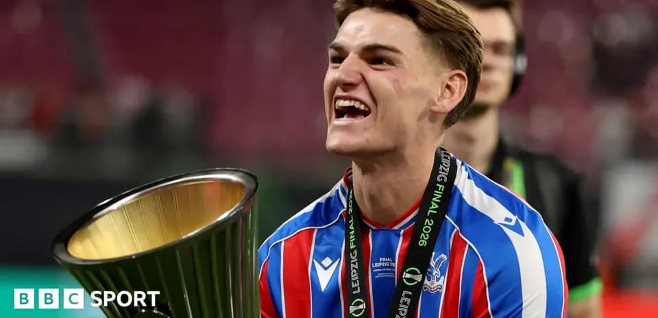 Player celebrating with trophy after winning match