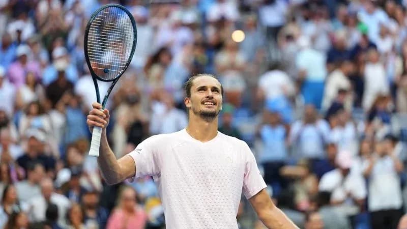 Player celebrating with racket raised after victory