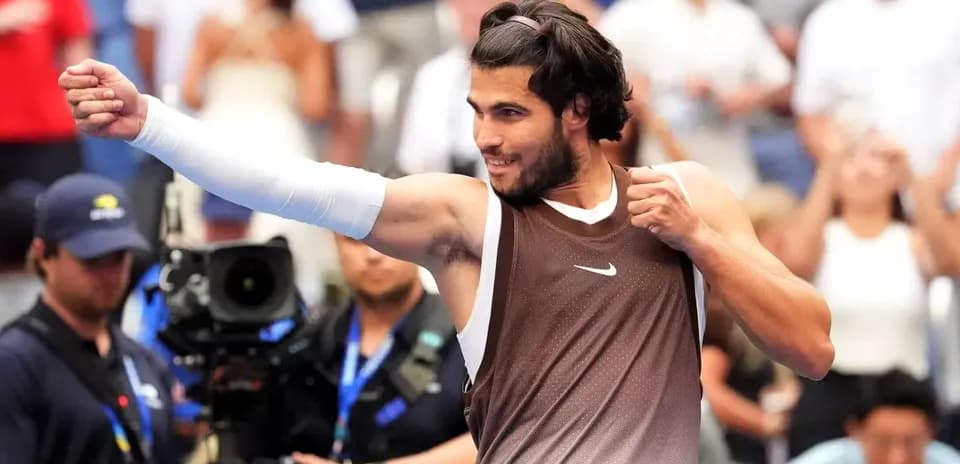 Tennis player celebrating after winning a match