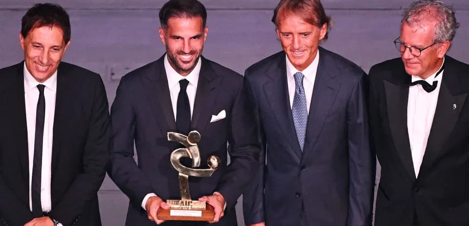 Four men posing with an award at ceremony