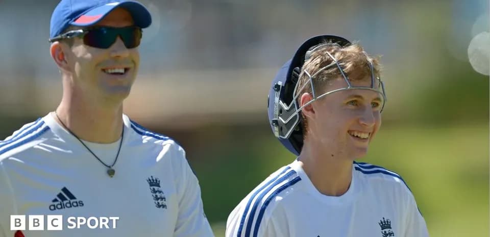 Two cricketers smiling during a training session