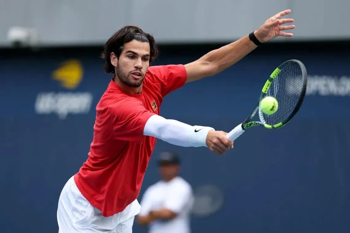 Player hitting a tennis ball during practice session