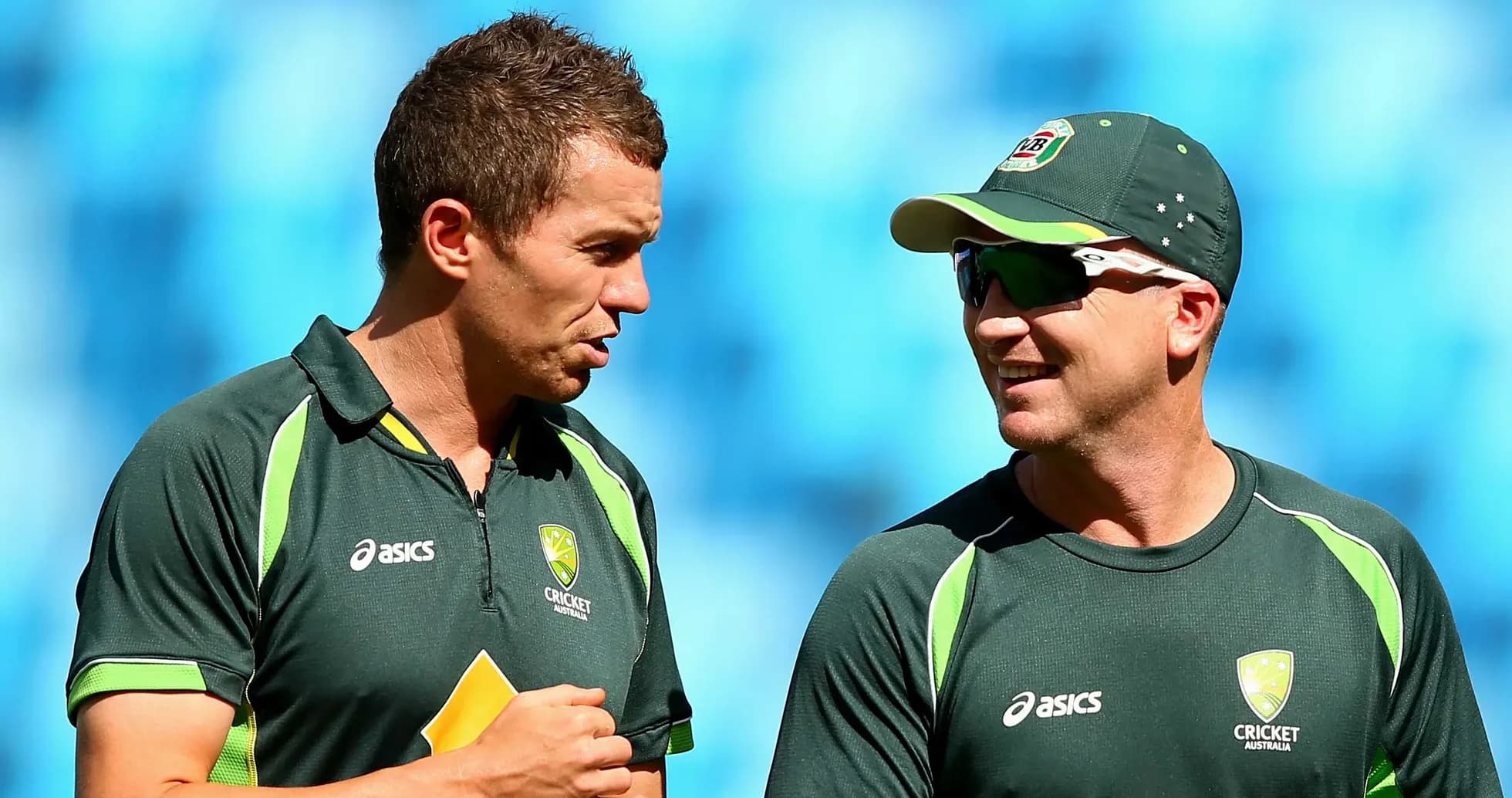 Two Australian cricketers talking during training session