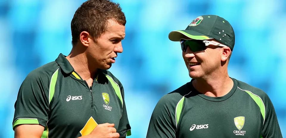 Two Australian cricketers talking during training session