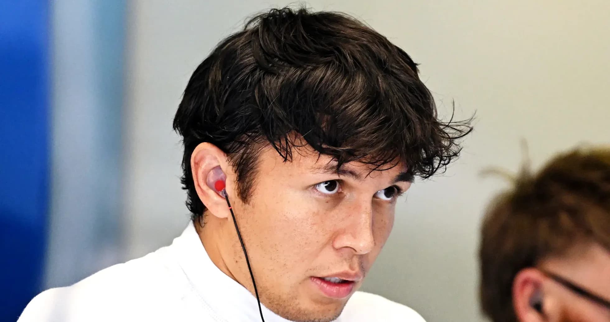 Driver wearing earphones during team meeting