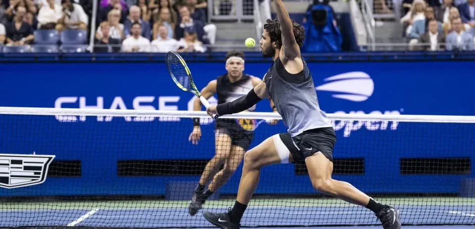Player lunging to hit a tennis ball during match