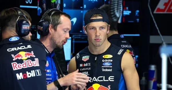 Team members discussing strategy in pit area