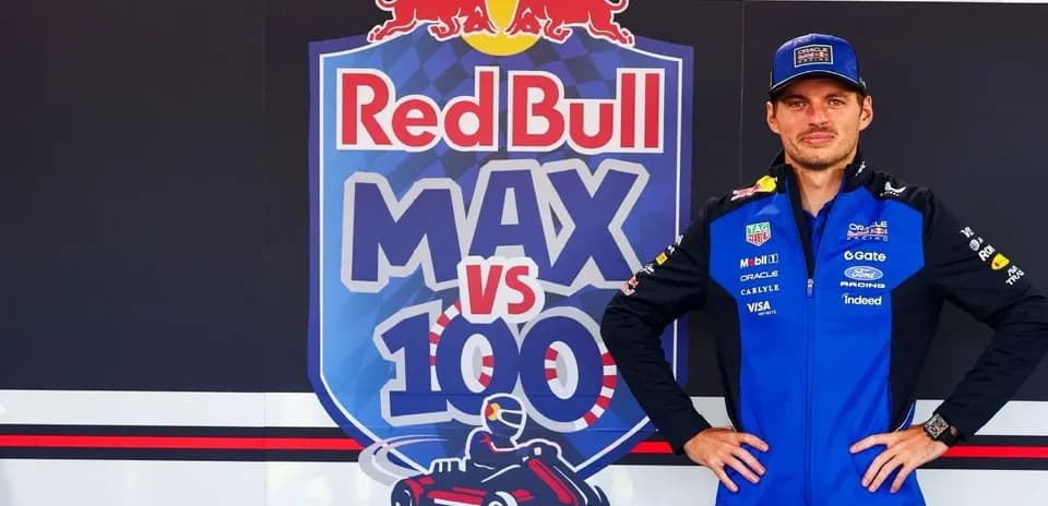 Driver posing in front of Red Bull branding