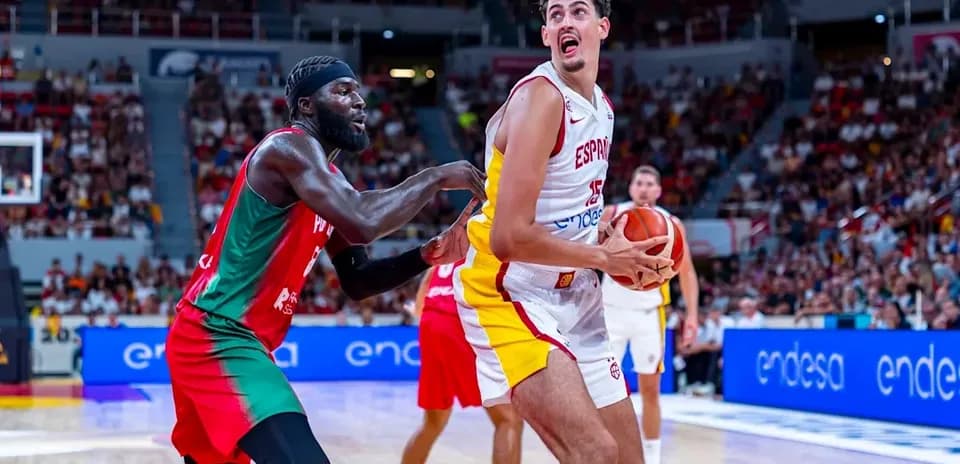 Spanish player with ball defended by opponent