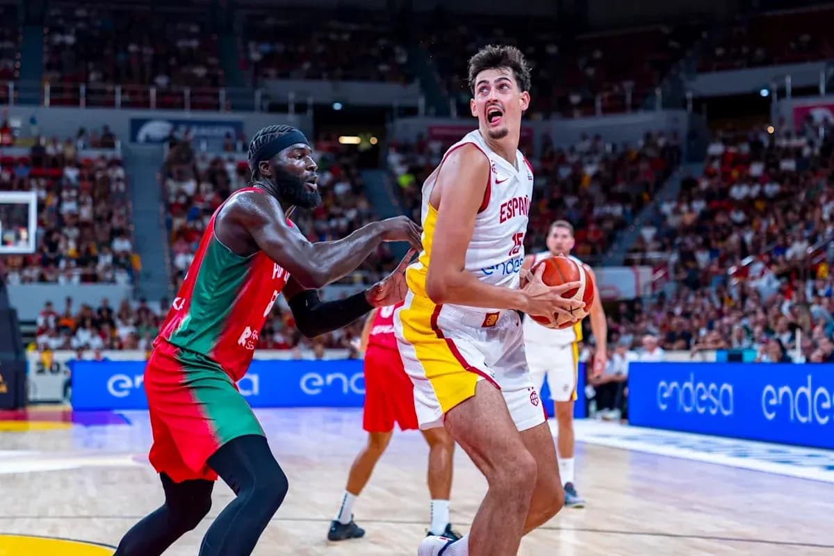 Spanish player with ball defended by opponent