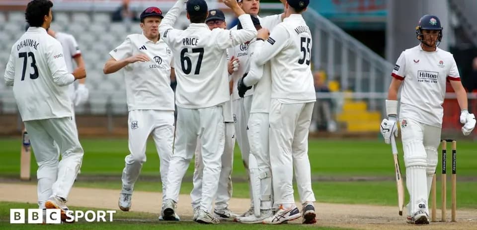 Cricket players celebrating a wicket on the field
