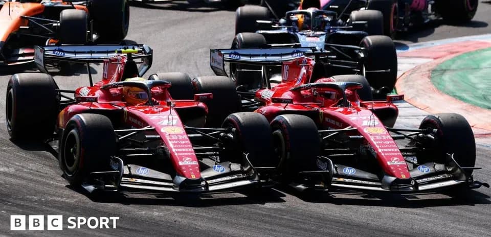 Two Ferrari cars racing closely during Formula 1 event