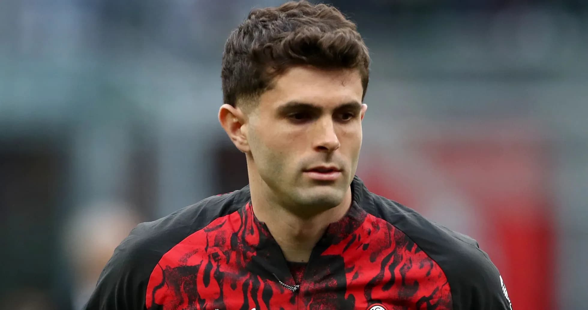 Player wearing red and black jersey during match