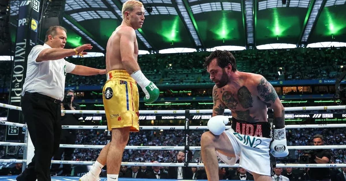 Boxers in ring with referee during match action