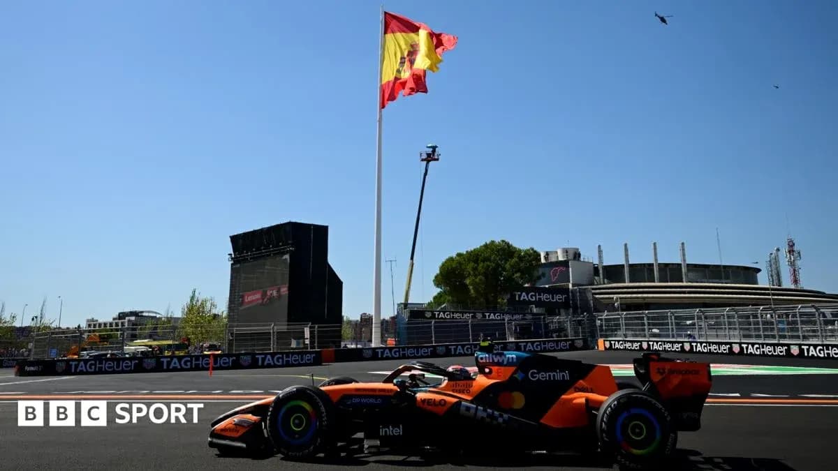 Formula 1 car racing near Spanish flag and grandstand