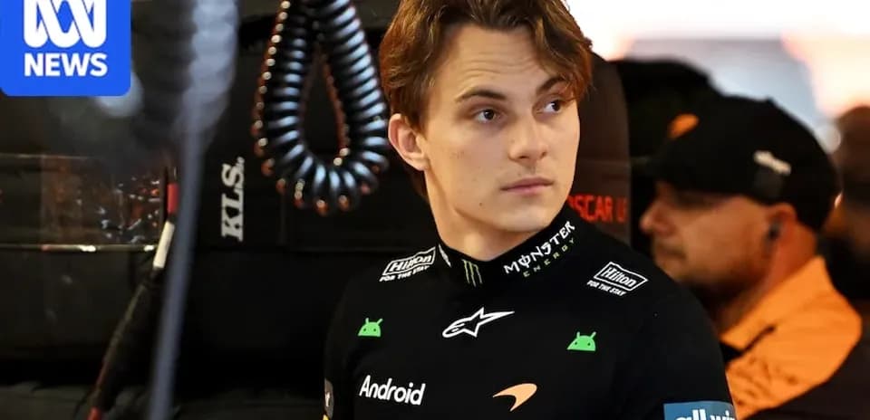 Driver in McLaren team uniform in garage